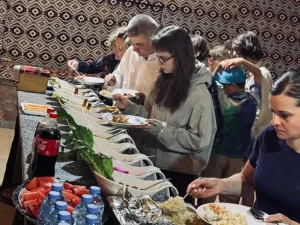 Guests serving themselves from a traditional Bedouin buffet dinner at Salem Camp in Wadi Rum.
